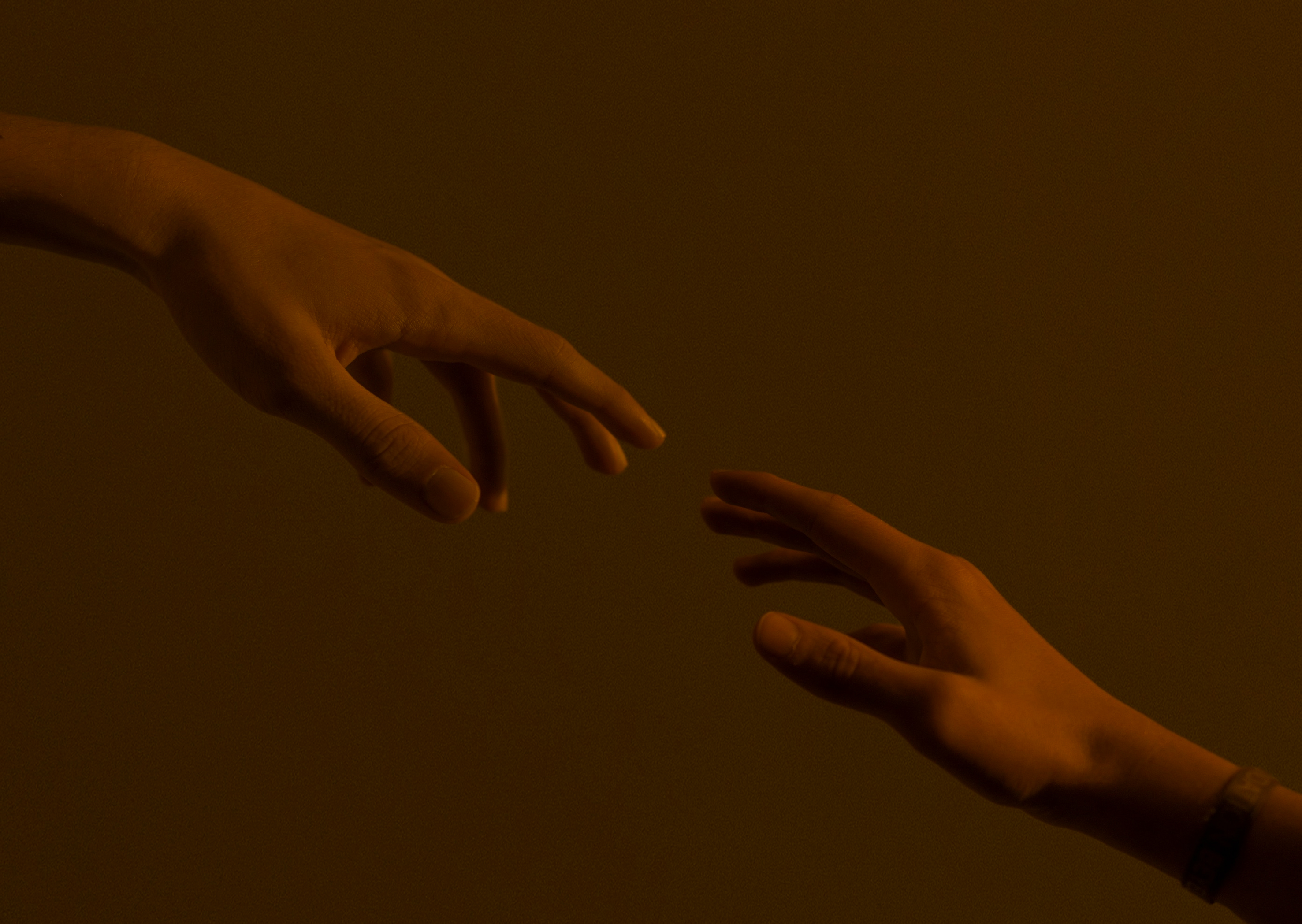 image of two hands reaching out.